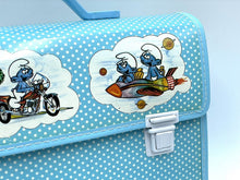 Load image into Gallery viewer, Back view of the blue Smurfs school bag with an interior view and handle.
