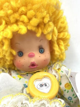 Load image into Gallery viewer, Close-up detail of Patapouf New Girl doll's face featuring big eyes and a smiling mouth.
