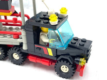 Load image into Gallery viewer, Detail view of the black LEGO truck with transparent windshield and detailed cab.
