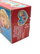 Load image into Gallery viewer, Side view of Mattel 1982 Baby That Away doll featuring blonde hair and heart logo.
