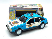 Load image into Gallery viewer, JUGUETES ROMAN COCHE ELECTRICO POLICE CAR lifestyle shot displaying police car toy with blue and white colors.
