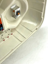 Load image into Gallery viewer, Close-up of a cream container with colorful buttons and interior compartments.
