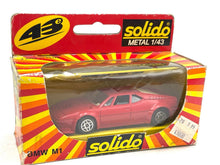 Load image into Gallery viewer, Vintage Solido 1209 BMW M1 1/43 diecast model car in red packaging with brand logo.
