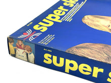 Load image into Gallery viewer, Detail view of the edge of the Super Ski game box showing the title and illustration.
