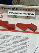 Load image into Gallery viewer, Detail of red plastic pieces from the Super Ski game showing various shapes.
