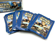 Load image into Gallery viewer, Star Wars themed trading card packs displayed in a lifestyle setting.
