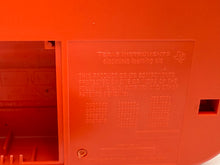 Load image into Gallery viewer, Detail view of the red Grillo Parlante showing text engraving.
