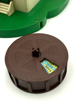Load image into Gallery viewer, Detail close-up of the brown circular wheel with a label
