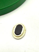 Load image into Gallery viewer, Detail close-up of a small black oval object from the toy set
