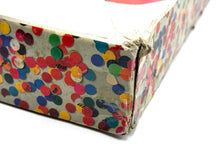 Load image into Gallery viewer, Detail view of the colorful box corner with confetti pattern.

