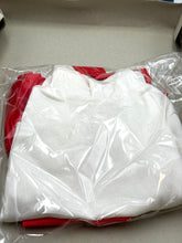 Load image into Gallery viewer, Detail of red and white fabric with smooth texture.
