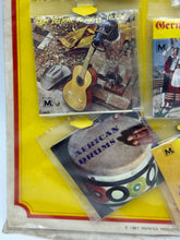 Load image into Gallery viewer, Various music albums displayed with colorful covers in a hanging display
