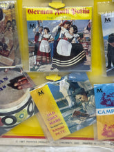 Load image into Gallery viewer, Various music albums displayed with colorful covers in a hanging display
