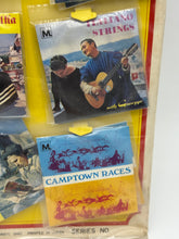 Load image into Gallery viewer, Various music albums displayed with colorful covers in a hanging display

