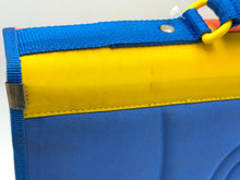 Load image into Gallery viewer, Detail view of the sturdy edge of the Digimon folder in blue and yellow.
