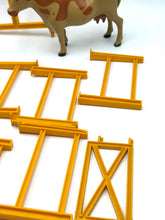 Carica l'immagine nel visualizzatore di Gallery, Mattel Sunshine Family Farm detail close-up of yellow toy fences with various fence pieces and a toy cow.

