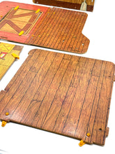 Carica l'immagine nel visualizzatore di Gallery, Close-up of wooden game boards with textured surface in the Sunshine Family Farm playset
