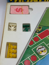 Carica l'immagine nel visualizzatore di Gallery, Detail of game components including a money card and game pieces

