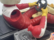Load image into Gallery viewer, Close-up detail of the driver's arm in red racing suit with gloved hand.
