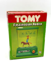 Load image into Gallery viewer, Original box of Rompin Cowboy Tomy Water Games showing storage wear and brand logo.
