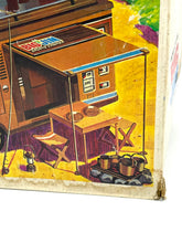 Load image into Gallery viewer, Detail view of the interior of the Big Jim Sports Camper showing furniture and kitchen area

