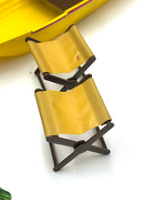 Load image into Gallery viewer, Close-up of yellow folding chairs with a stackable design
