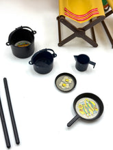 Load image into Gallery viewer, Lifestyle shot of black kitchenware included in the camping accessories
