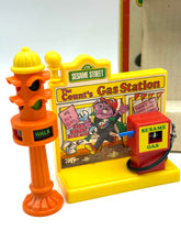 Load image into Gallery viewer, Detail view of toy gas station from Sesame Street Playset with colorful design.
