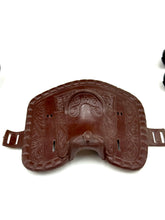 Load image into Gallery viewer, Detail shot of a brown leather pad with a contoured shape and straps.
