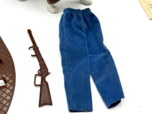 Load image into Gallery viewer, Detail close-up of the blue pants and toy rifle accessories included in the set.
