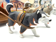 Load image into Gallery viewer, Detail close-up of the dog figurine with harness from the playset.
