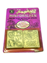 Carica l'immagine nel visualizzatore di Gallery, Mattel Thing Maker Mini Dragon Pack packaging with gold decorative stamps.
