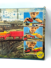 Load image into Gallery viewer, Fischertechnik Bau-Spiel-Bahn Train Playset cover displaying train illustration and colorful background.
