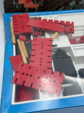 Load image into Gallery viewer, Close-up of red building blocks from Fischertechnik Bau-Spiel-Bahn Train Playset in stacked arrangement.
