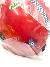 Load image into Gallery viewer, Detail close-up of a red helmet with logo and plastic wrap.
