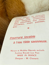 Load image into Gallery viewer, Close-up detail of the tag showing printed text on cardboard.
