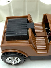 Load image into Gallery viewer, Interior detail of the Jeep Renegade toy highlighting the seating area and battery compartment.

