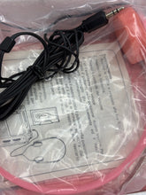 Load image into Gallery viewer, Detail of the pink device wrapped in plastic with visible cables
