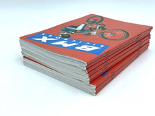Carica l'immagine nel visualizzatore di Gallery, Another side view of the Vintage BMX notebook highlighting its thick spine and illustrated cover.

