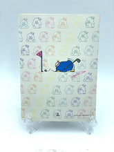 Carica l'immagine nel visualizzatore di Gallery, Front view of the 1985 Sanrio Tuxedosam notebook with colorful doodles and a smiling character.
