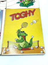 Carica l'immagine nel visualizzatore di Gallery, Detail close-up of a cartoon crocodile holding a tennis racket with bubbles.
