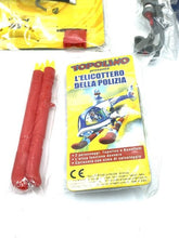 Load image into Gallery viewer, Detail view of toy helicopter accessories including red launchers and instruction booklet.
