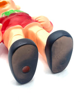 Load image into Gallery viewer, Close-up detail of elf figurine feet showing flat soles and red dot.

