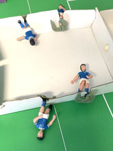 Load image into Gallery viewer, Miniature soccer players in blue and green on the soccer field.
