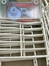 Load image into Gallery viewer, Detail view of plastic components for Pimea Chalet toy bird house in clear and blue.
