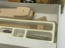 Load image into Gallery viewer, Detail shot of wooden model parts displayed in a plastic container.
