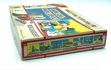 Load image into Gallery viewer, Detail close-up of game components including colorful game pieces and instruction sheet.

