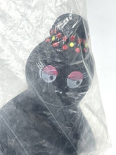 Load image into Gallery viewer, Detail view of the black toy figure from Fabianplastica in plastic packaging.
