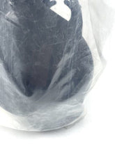 Load image into Gallery viewer, Close-up detail of the black toy figure from Fabianplastica with colorful spots in plastic packaging.
