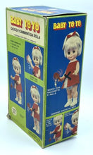 Load image into Gallery viewer, Close-up of the packaging for the 1967 Mattel Walk n Play doll showing colorful details.
